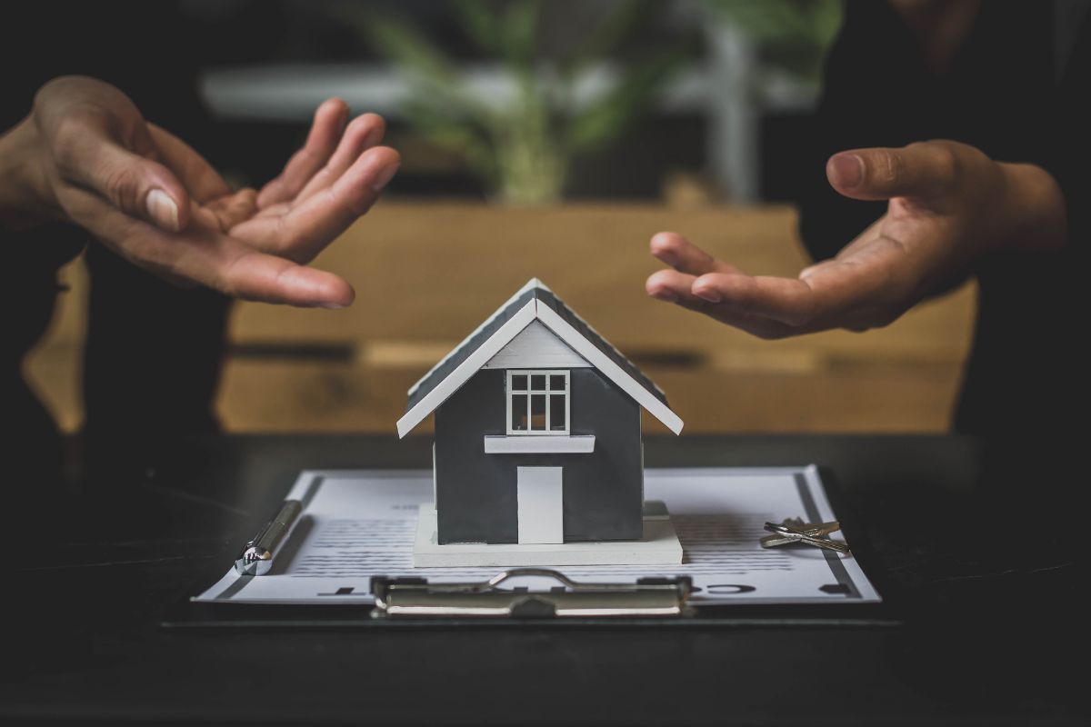 Residential tenancy agreement document with house keys and wooden house model